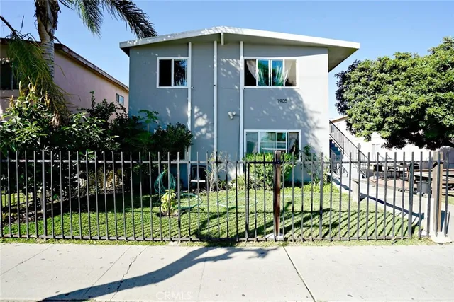 a view of a house with a small yard and plants