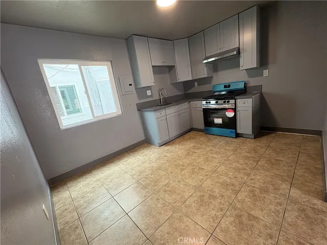 a kitchen with stainless steel appliances a sink a stove a microwave and cabinets