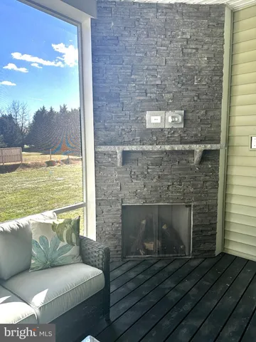 a living room with furniture two large window