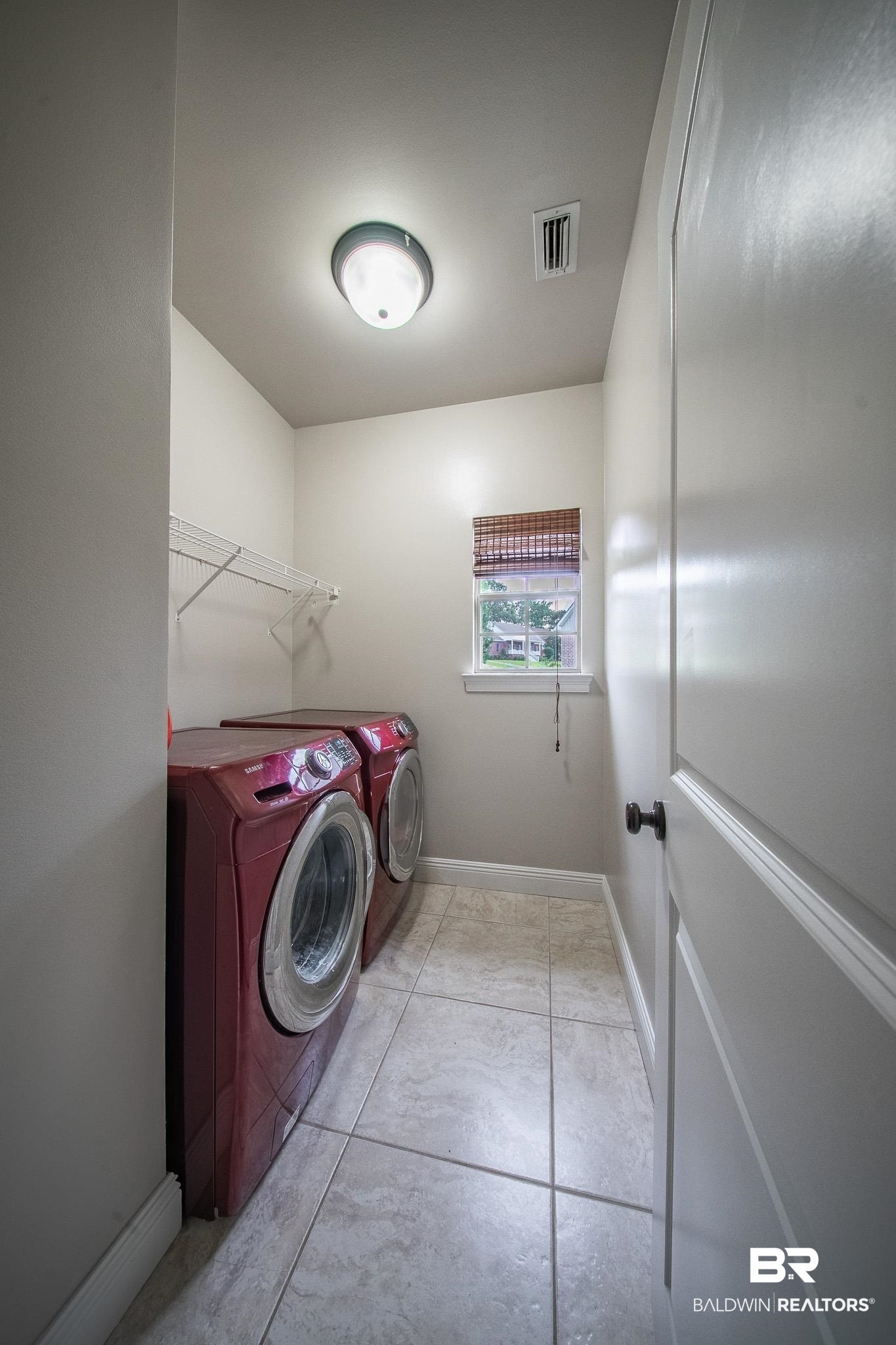 8421 Weatherford Court Daphne, AL 36527 - Photo 31 of 36 Laundry room featuring washer and clothes dryer and baseboards