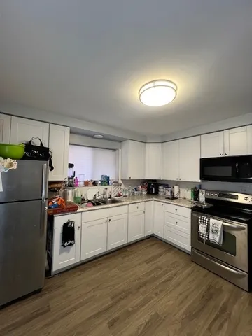 a kitchen with a stove top oven and refrigerator