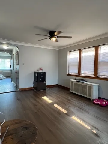 a living room with furniture and a floor to ceiling window