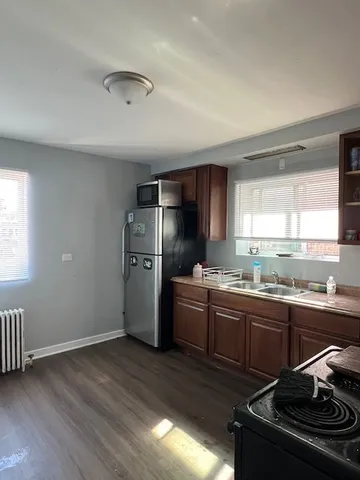 a kitchen with a sink appliances and cabinets