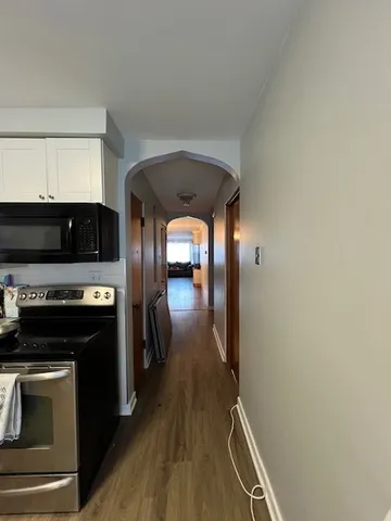 a kitchen with granite countertop a stove and a refrigerator