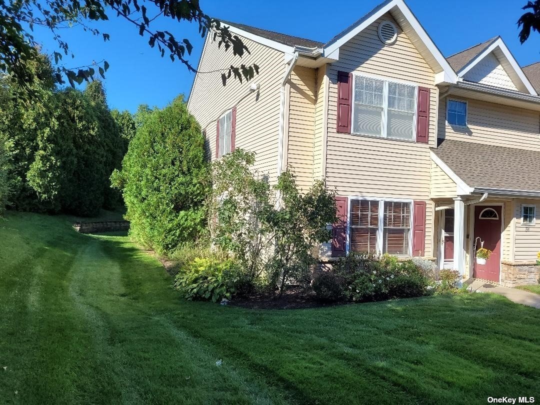 133 Morley Circle Melville, NY 11747 - Photo 1 of 12 a front view of a house with a yard