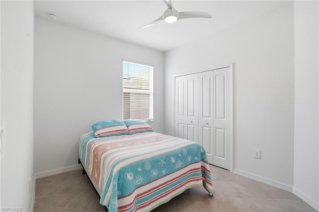 2215 Dragonfruit Way Naples, FL 34120 - Photo 27 of 38 a bedroom with a bed and a window