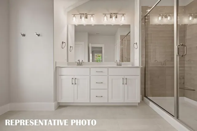 a view of a bathroom with mirror and shower