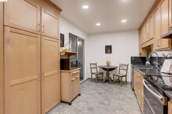 a kitchen with stainless steel appliances granite countertop a refrigerator sink and cabinets