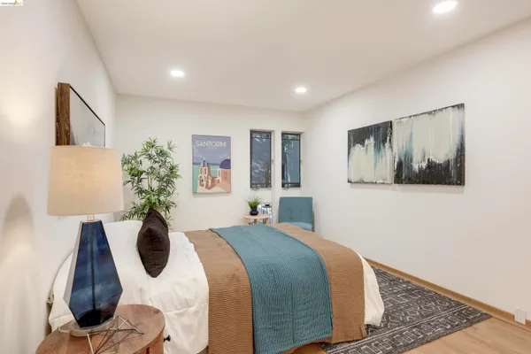 a bedroom with a bed and a painting on the wall