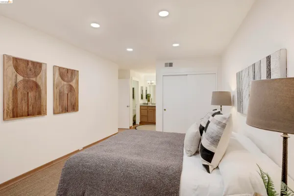 a bathroom with a granite countertop sink a mirror and a shower