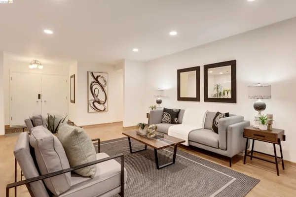a dining room with furniture and a floor to ceiling window