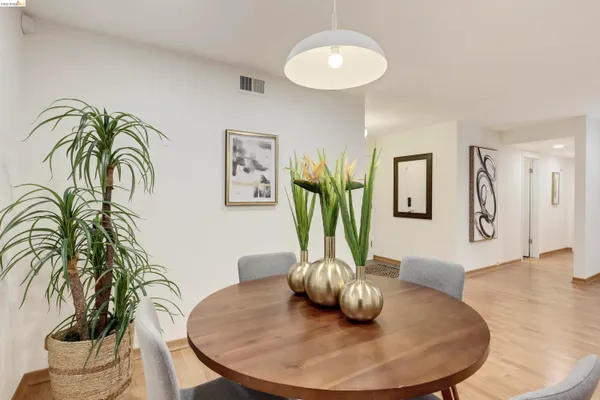 a kitchen with stainless steel appliances granite countertop a refrigerator sink stove and white cabinets