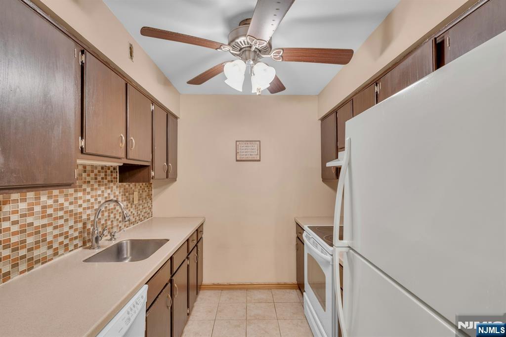 666 Mill Street, Unit C6 Belleville, NJ 07109 - Photo 9 of 25 a kitchen with stainless steel appliances granite countertop a sink and a refrigerator