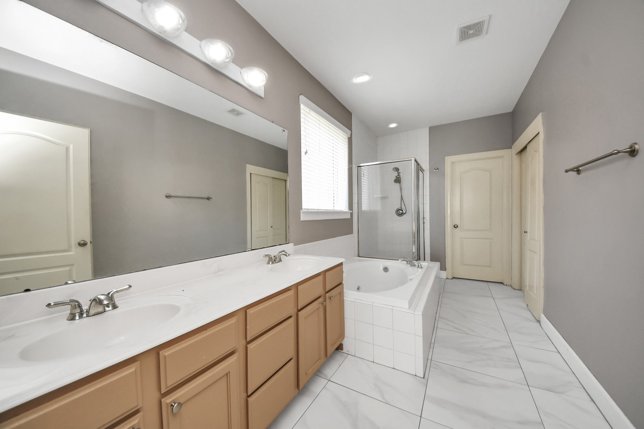 4610 Plum Forest Road Houston, TX 77084 - Photo 13 of 41 The bath features, dual sinks, a jetted tub, separate shower and LARGE closet.