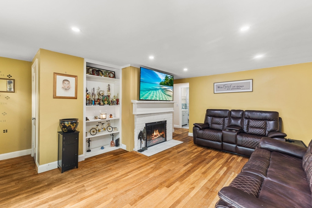 28 Maple Circle Randolph, MA 02368 - Photo 4 of 24 a living room with furniture and a fireplace