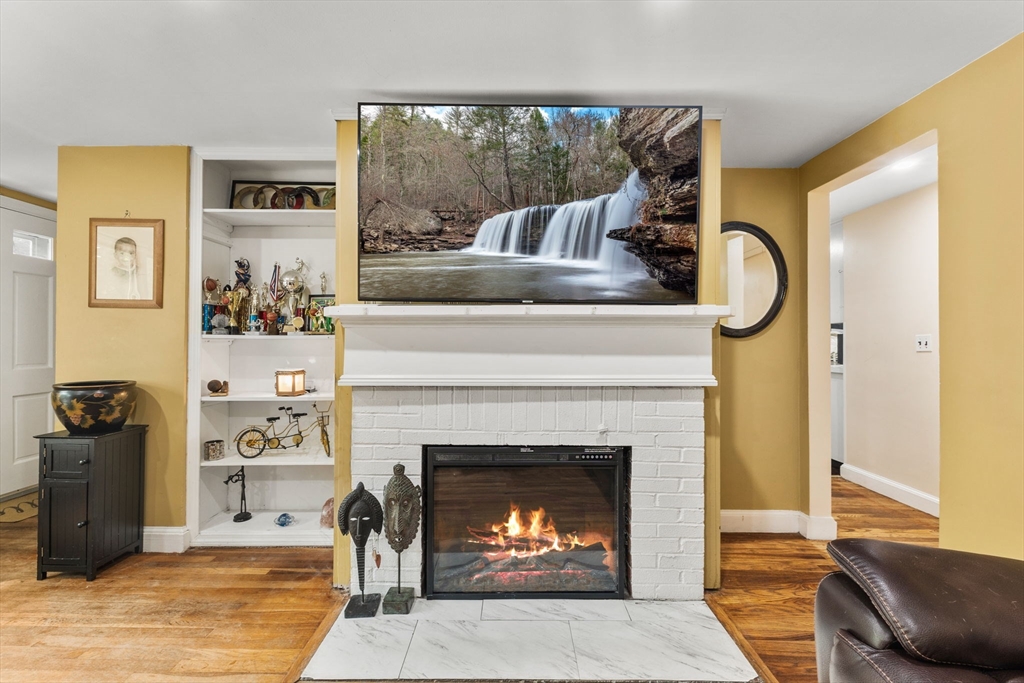28 Maple Circle Randolph, MA 02368 - Photo 7 of 24 a living room with furniture and a fireplace