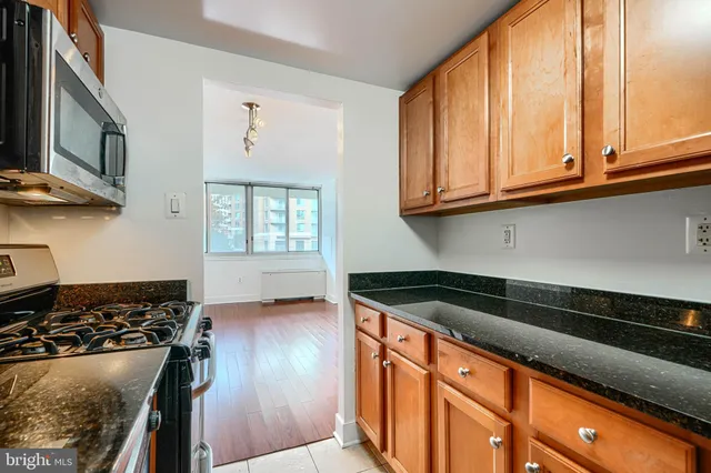 a kitchen with granite countertop a stove and a sink