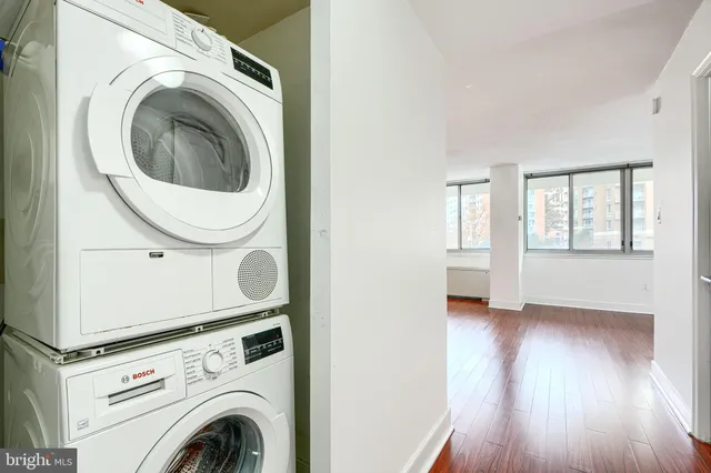 a view of a hallway with washer and dryer