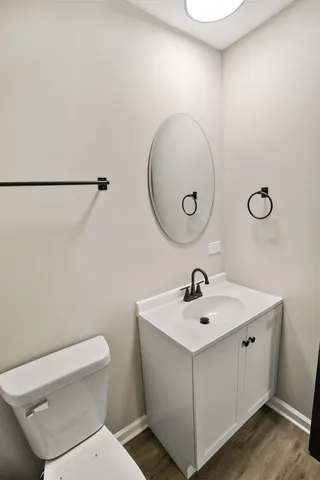 a bathroom with a sink mirror and toilet