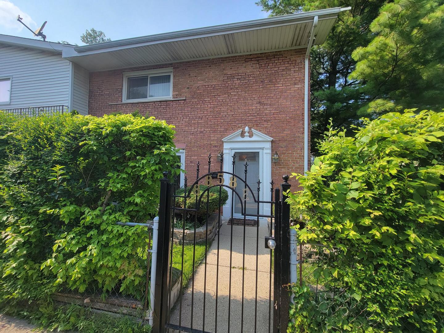 8858 Dee Road, Unit E Des Plaines, IL 60016 - Photo 1 of 1 a front view of a house with a yard