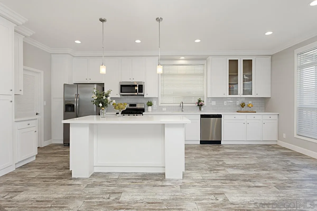 a kitchen with a sink cabinets and window