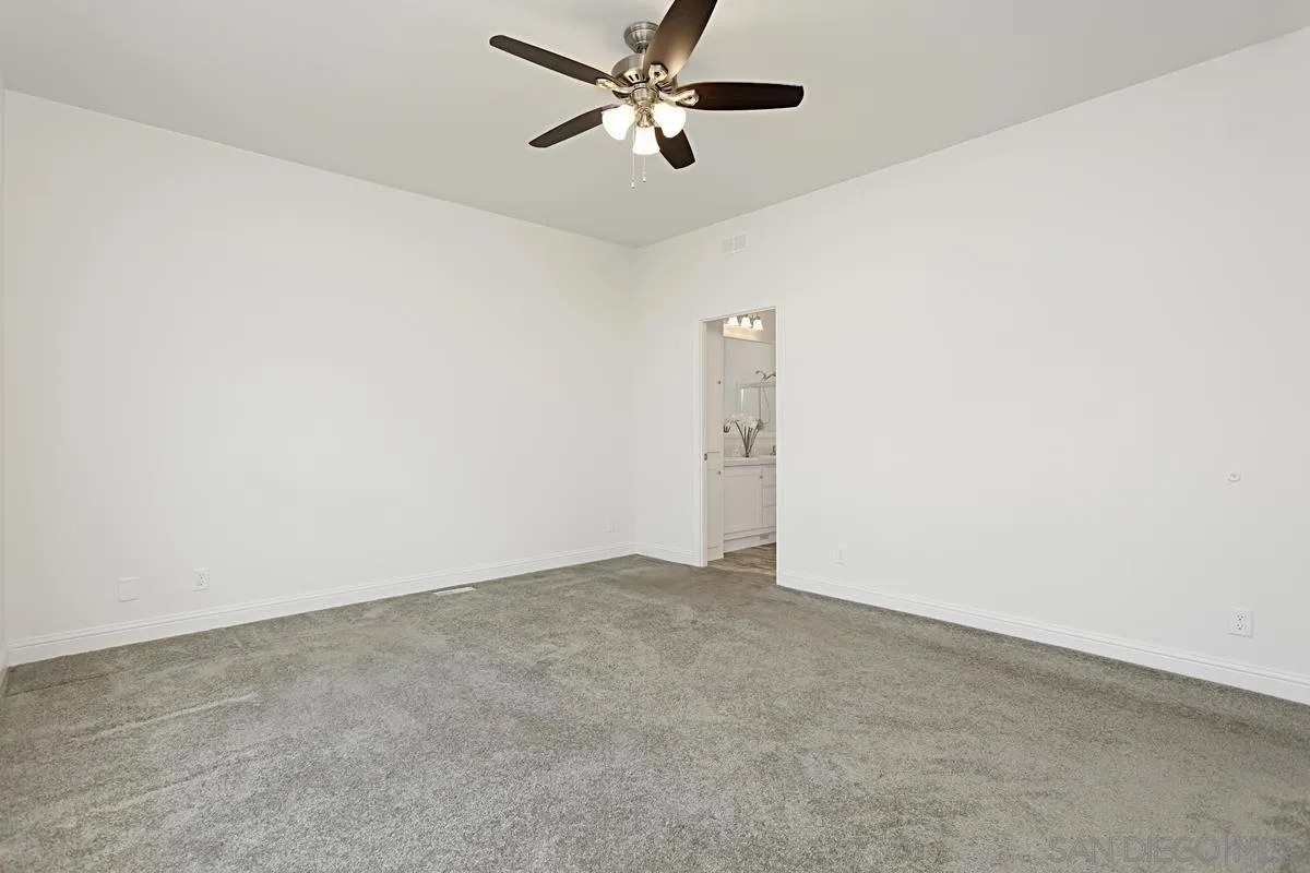13335 Buena Vista Poway, CA 92064 - Photo 17 of 26 an empty room with closet and a ceiling fan