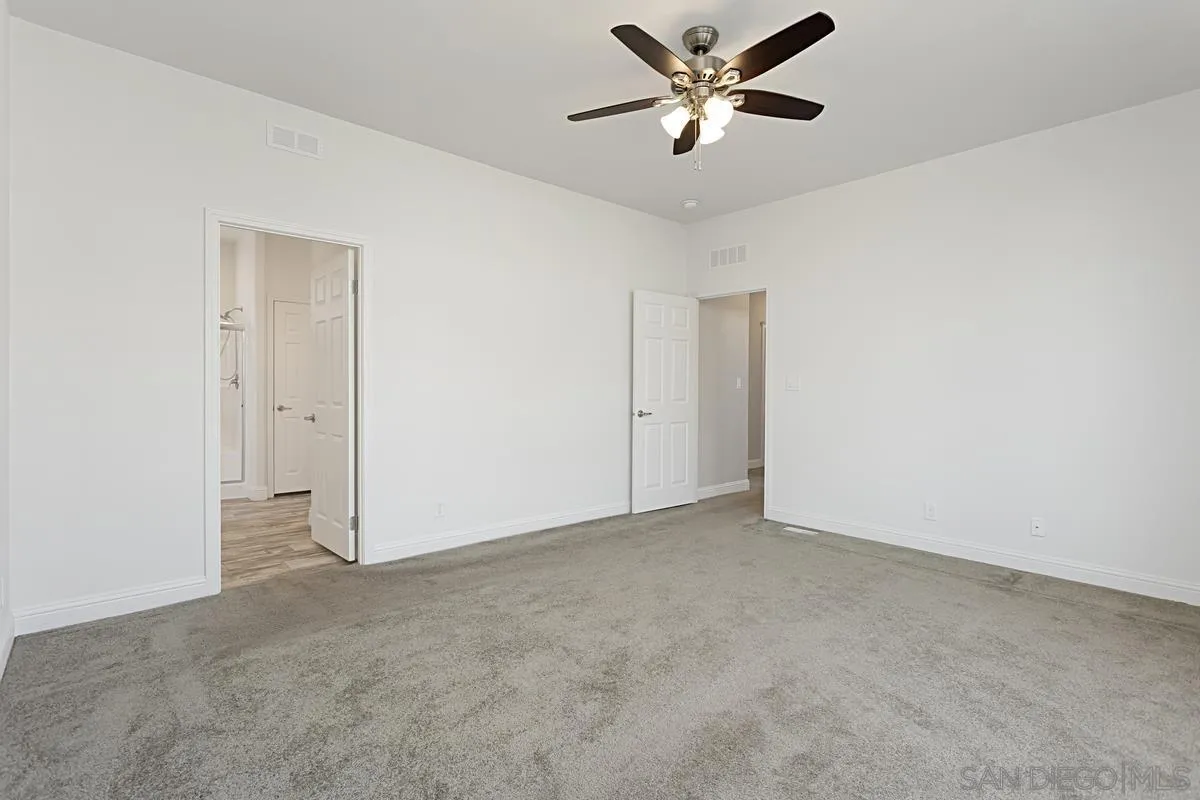 13335 Buena Vista Poway, CA 92064 - Photo 18 of 26 an empty room with closet and a ceiling fan