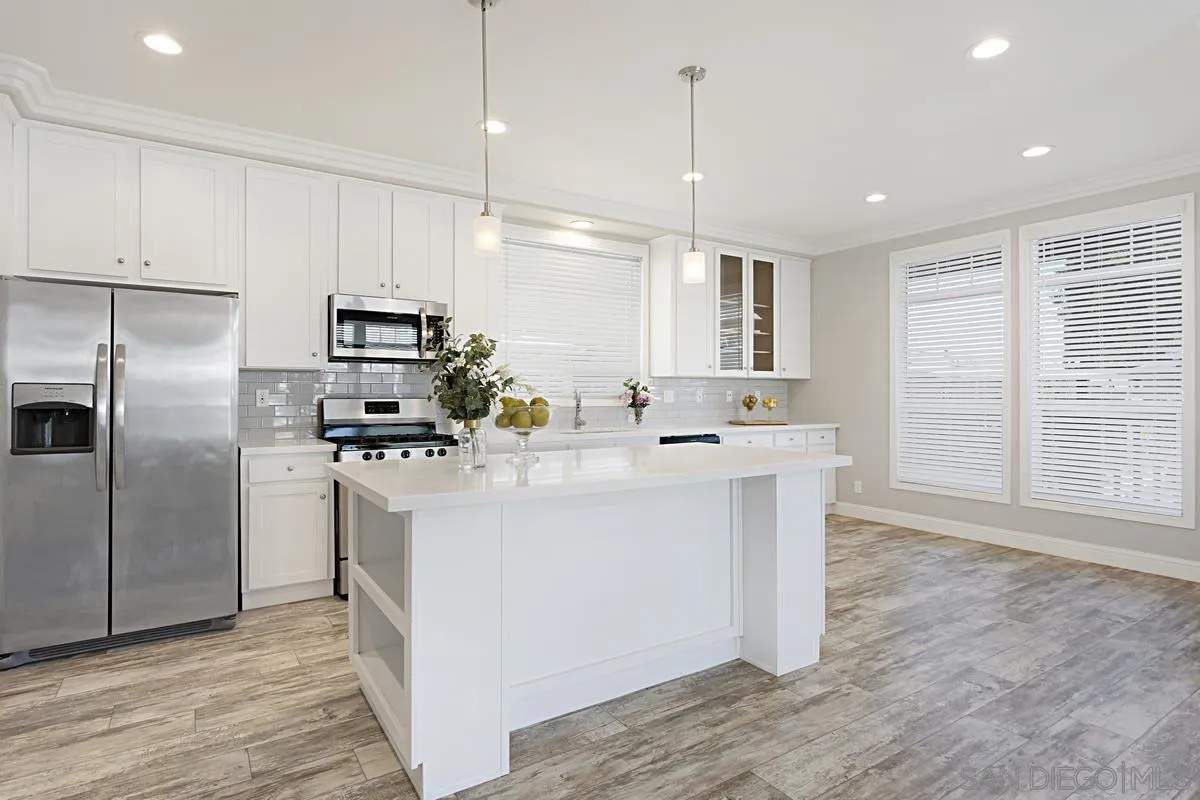13335 Buena Vista Poway, CA 92064 - Photo 9 of 26 a kitchen with kitchen island a sink stainless steel appliances and cabinets