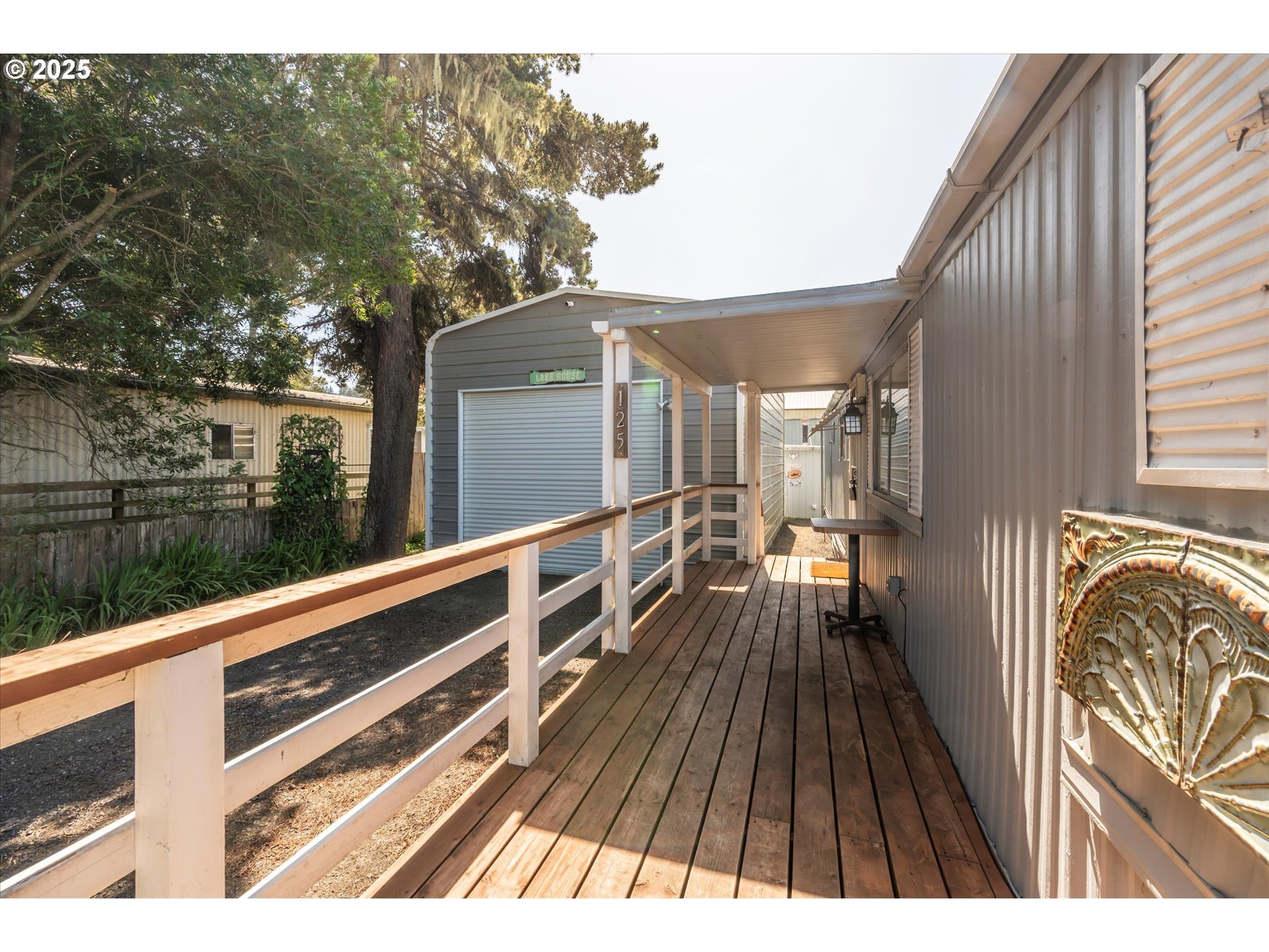 125 North 4th Street Lakeside, OR 97449 - Photo 4 of 38 a view of balcony with wooden floor and fence