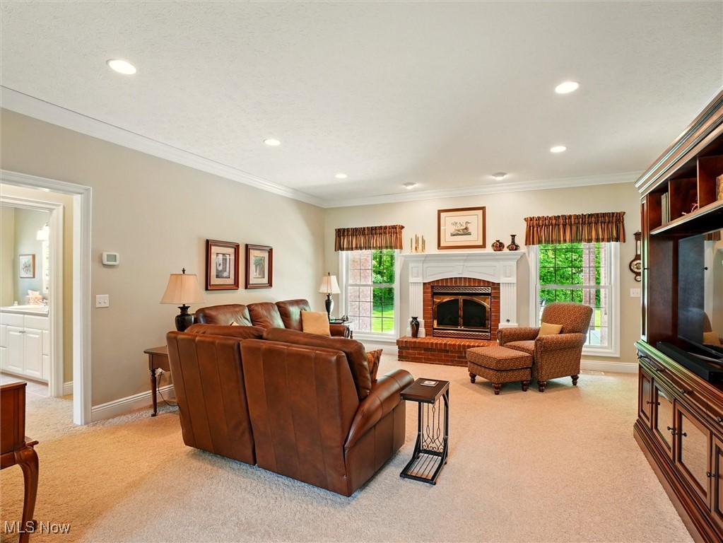 4440 Rutledge Avenue Ashtabula, OH 44004 - Photo 6 of 50 Living area with light carpet, a brick fireplace, recessed lighting, and ornamental molding