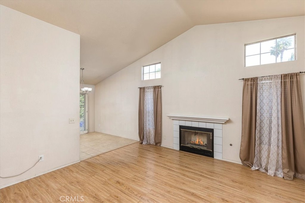 43115 Corte Landeros Temecula, CA 92592 - Photo 7 of 42 a view of a livingroom with wooden floor and a fireplace