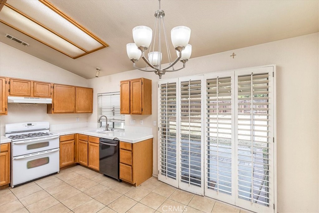 43115 Corte Landeros Temecula, CA 92592 - Photo 9 of 42 a kitchen with stainless steel appliances granite countertop a stove a sink and a microwave