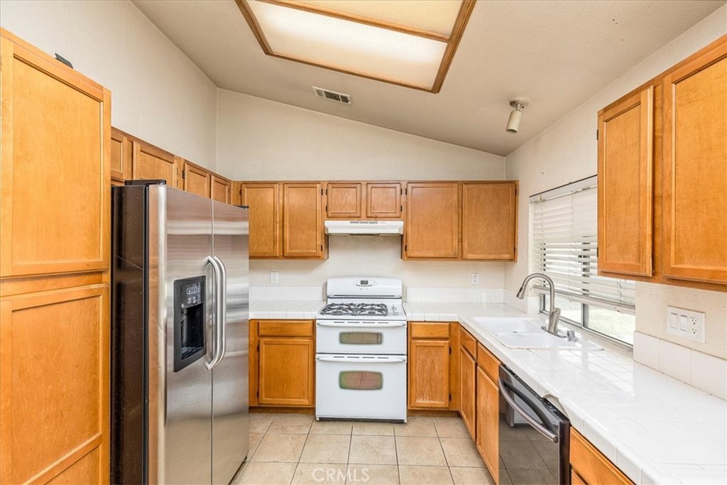 43115 Corte Landeros Temecula, CA 92592 - Photo 10 of 42 a kitchen with a stove top oven sink and refrigerator
