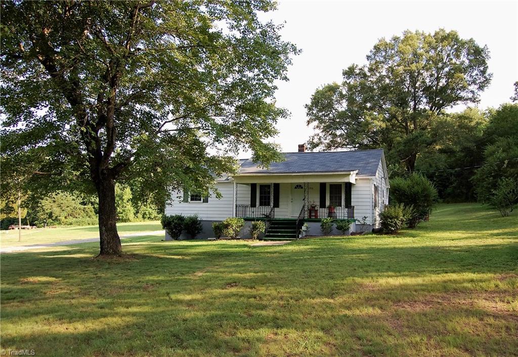 1395 Smothers Road Madison, NC 27025 - Photo 2 of 25 Front view of the house. Enjoy the shade on this covered front porch.