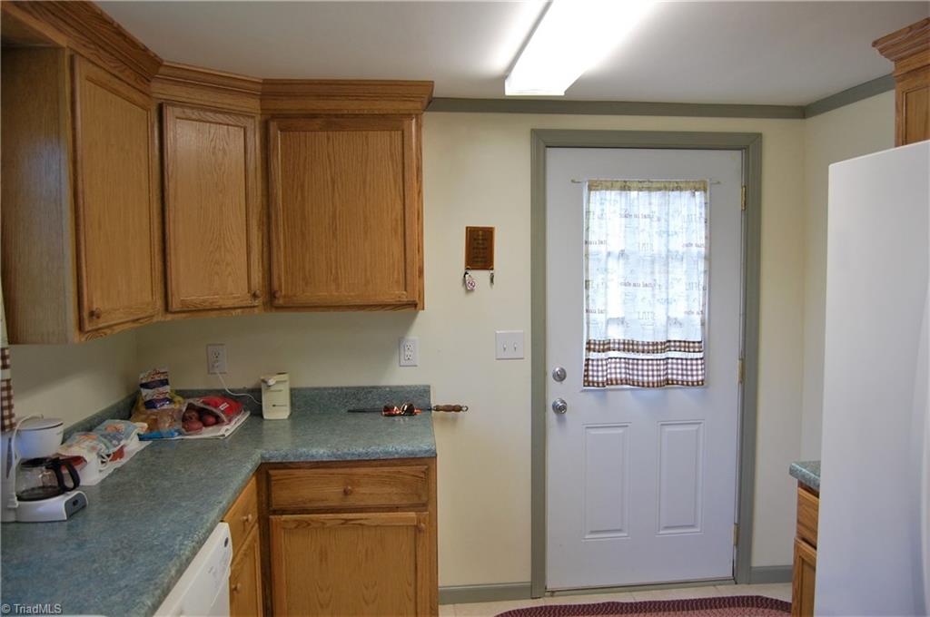 1395 Smothers Road Madison, NC 27025 - Photo 18 of 25 This kitchen features more then enough counter top and storage to satisfy the chef in your life. The door leads to the back deck.