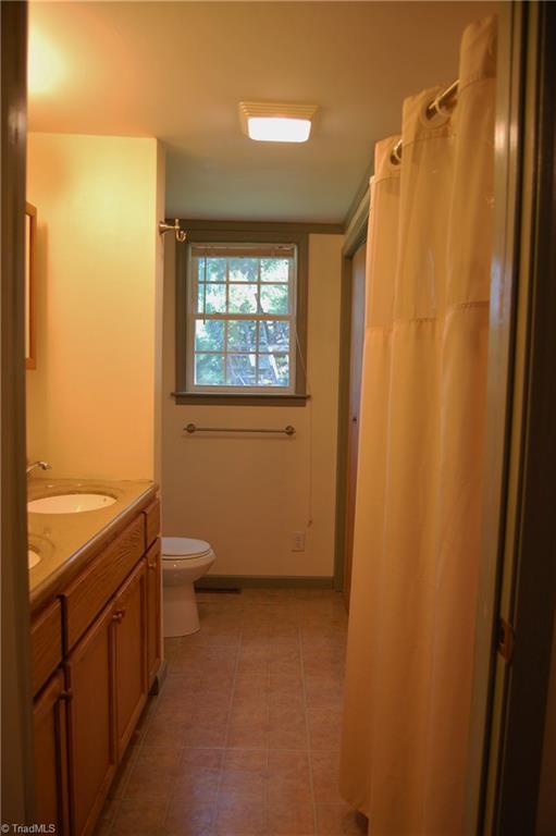 1395 Smothers Road Madison, NC 27025 - Photo 21 of 25 The full bath features double sinks, large tub/shower, and huge storage closet.