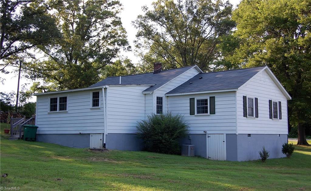 1395 Smothers Road Madison, NC 27025 - Photo 4 of 25 View of the rear and side of the home, note the heat pump that was installed in 2013.