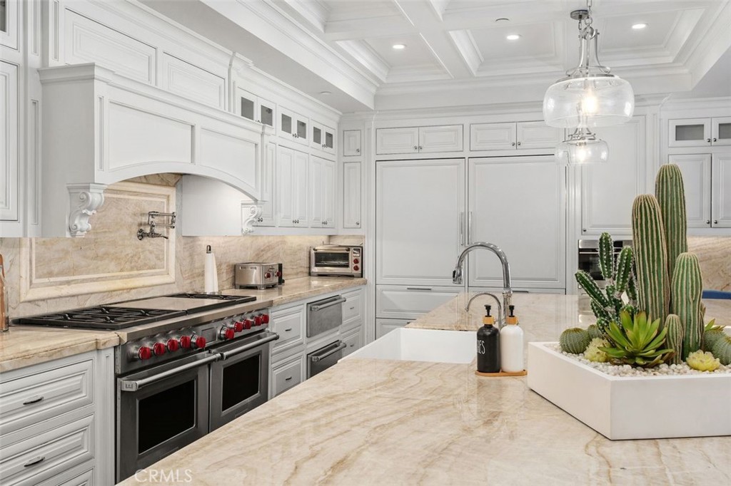 4 Inverness Lane Newport Beach, CA 92660 - Photo 15 of 56 a kitchen with kitchen island granite countertop a sink stainless steel appliances and cabinets