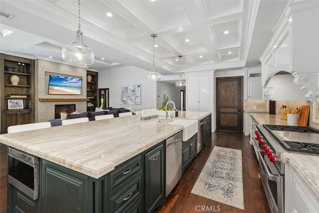 4 Inverness Lane Newport Beach, CA 92660 - Photo 16 of 56 a large kitchen with stainless steel appliances granite countertop a large center island and a sink
