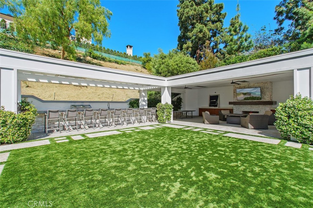 4 Inverness Lane Newport Beach, CA 92660 - Photo 39 of 56 a view of a patio with table and chairs and potted plants with wooden floor and fence