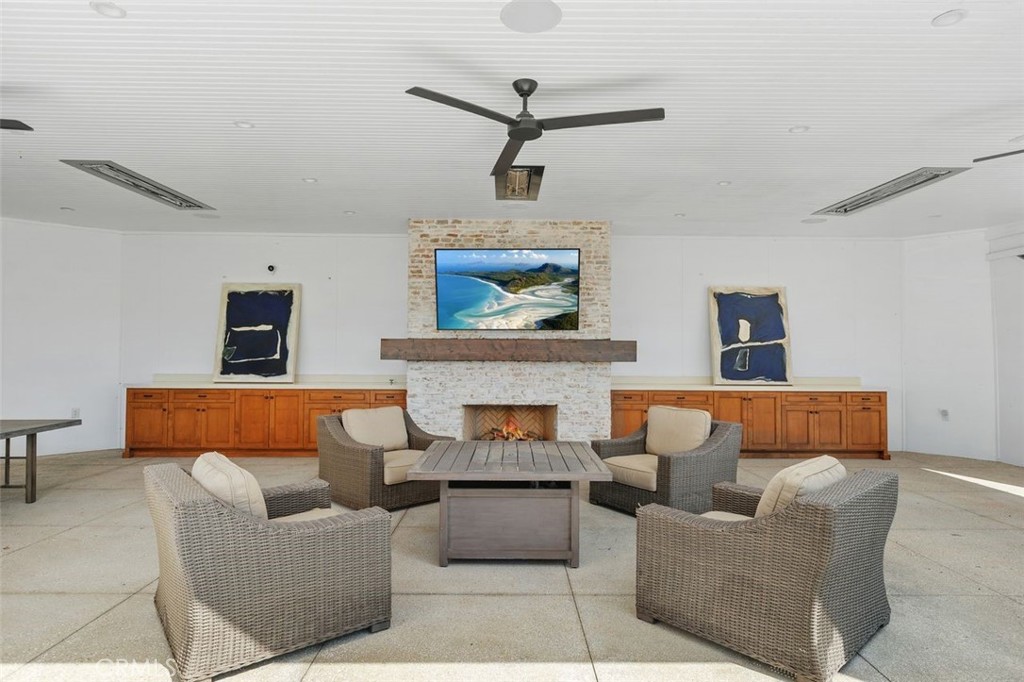 4 Inverness Lane Newport Beach, CA 92660 - Photo 40 of 56 a living room with furniture and a fireplace