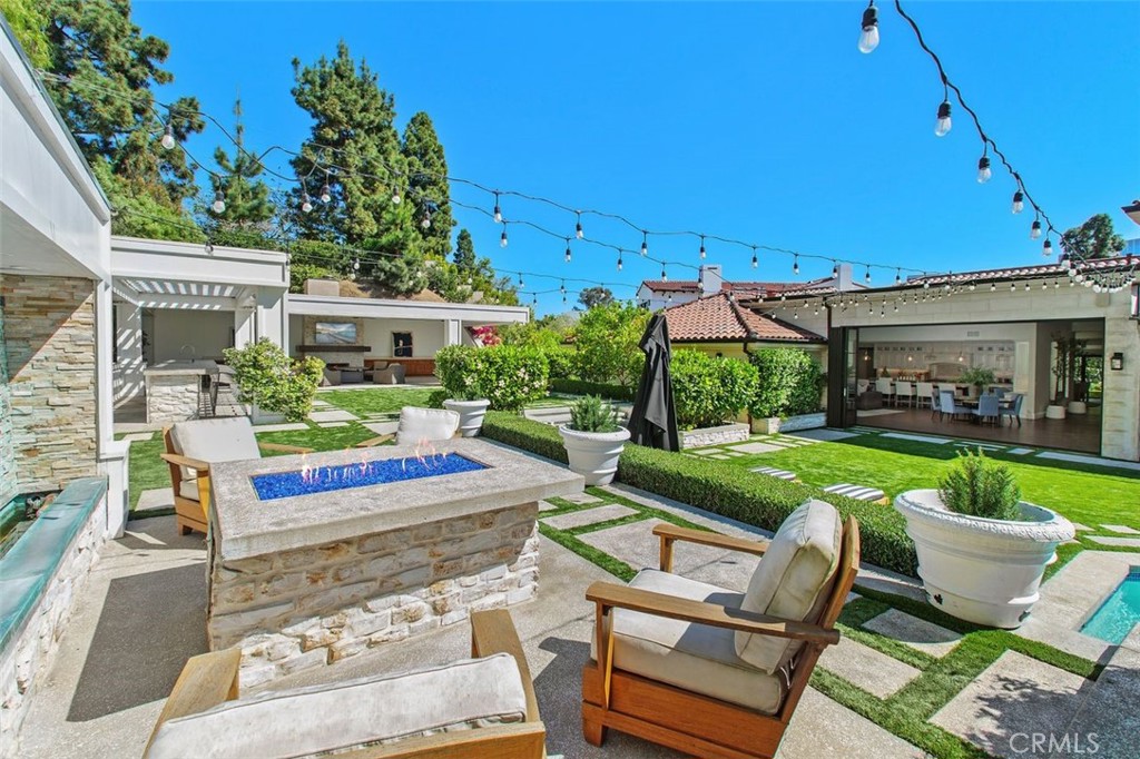 4 Inverness Lane Newport Beach, CA 92660 - Photo 43 of 56 a view of an outdoor sitting area with a table and chairs