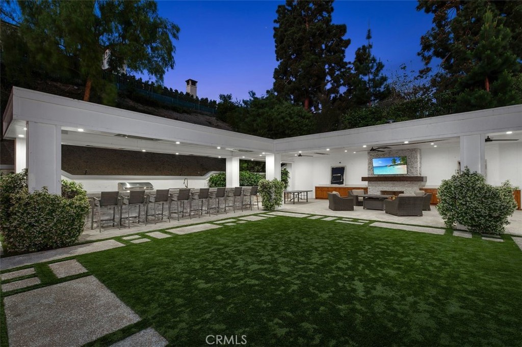 4 Inverness Lane Newport Beach, CA 92660 - Photo 50 of 56 a front view of a house with a garden and sitting area