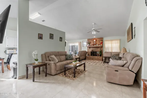 a living room with furniture and a flat screen tv