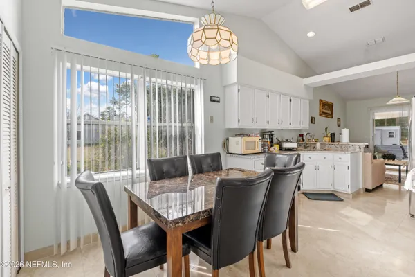 a view of a dining room with furniture window and outside view
