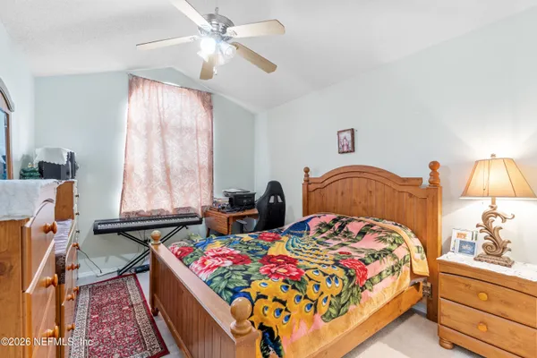 a bedroom with a bed and window