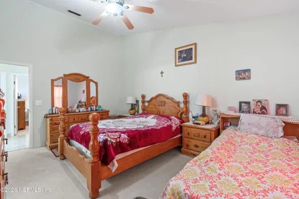 a bedroom with two beds and a chandelier