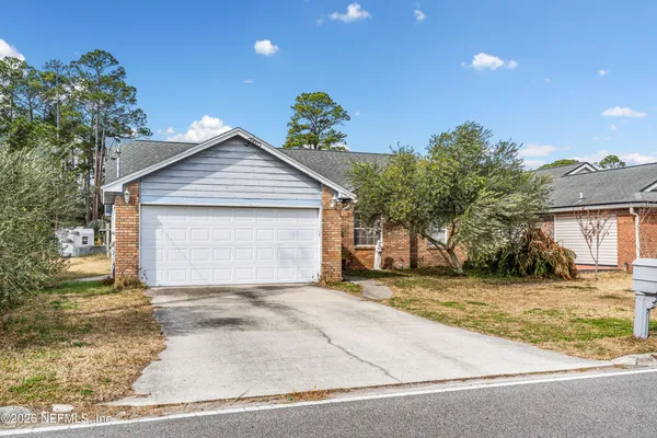 a view of a house with a yard and garage