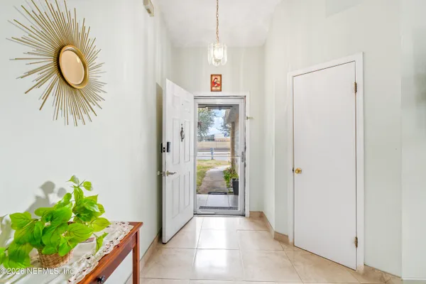 a view of a hallway to a livingroom with furniture