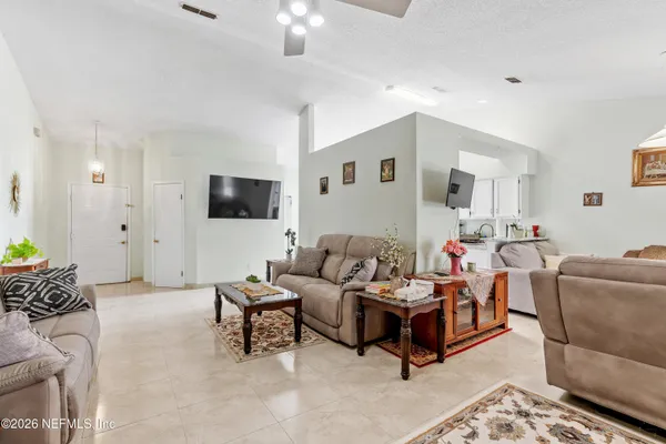 a living room with furniture and a flat screen tv